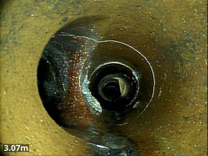 A circumferential crack within a drain pipe