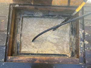Jet clearing a blocked drainage system.